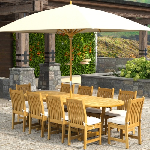 70166 Montserrat Veranda 11pc Dining Set with optional Umbrella and cushions on patio with pergola with hanging plants and vines and landscape plants in background