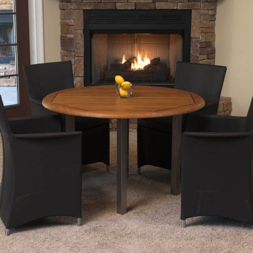  70236 Vogue Apollo 5 piece Dining Set of 4 armchairs in tobacco colored textilene fabric and a teak and stainless steel 4 foot round table with 3 lemons on table in front of fireplace