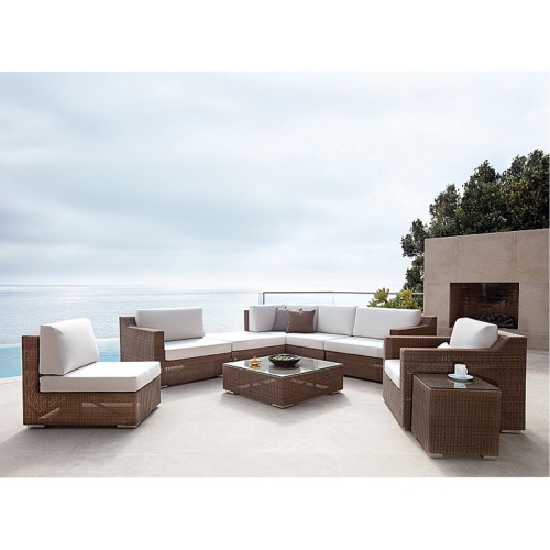 70240 malaga nine piece synthetic woven wicker set with bowl apples coffee cup on patio with glass balcony outdoor fireplace and trees in background overlooking ocean and blue sky