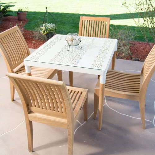 70420 Bloom Laguna teak and powder coated aluminum 5 piece Dining Set of Bloom 32 inch square dining table with glass top and round vase and 4 teak dining chairs on paver patio