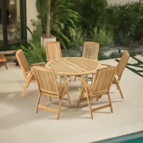 70480 Vogue Reclining Dining Set for 6 on a pool deck angled aerial view next to a pool and windows with landscaping trees and shrubs in the background