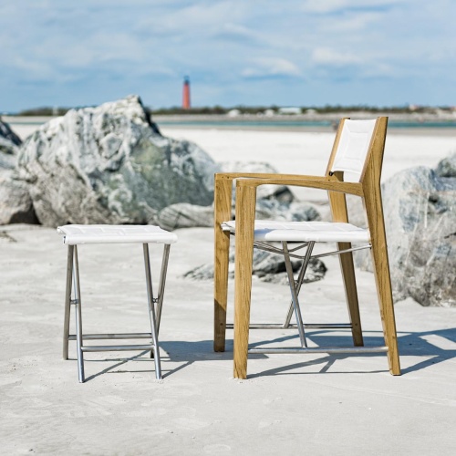70769 odyssey teak and stainless steel folding chair and ottoman set angled with white background