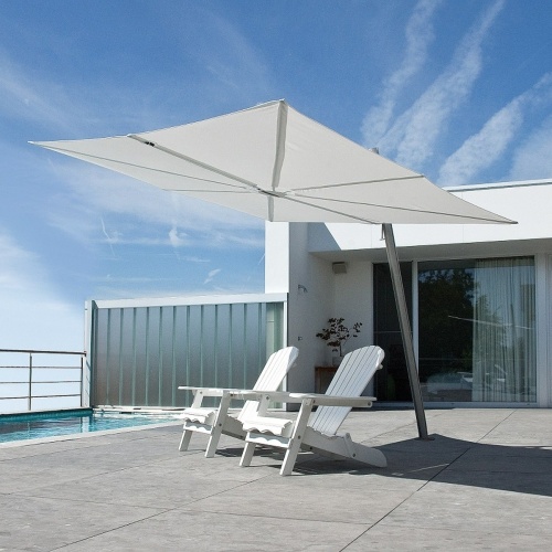 SP25100SET Spectra Solo Umbrella and Paver Base with two Adirondack chairs on concrete paver deck set pool view blue sky railing fence house and glass door in background 