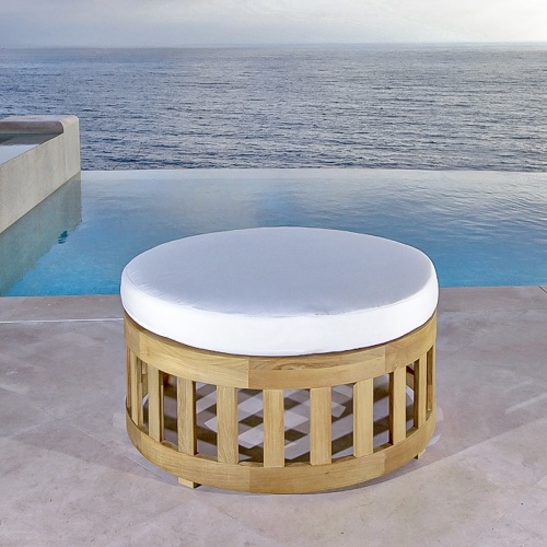 14171DP Kafelonia 36 inch Ottoman on concrete patio in front of landscape plants overlooking ocean in background