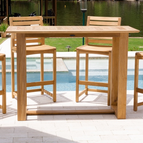 15999 Horizon Teak Bar Table on concrete deck with pool and somerset side barstools in background