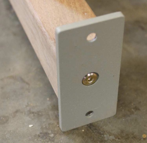 40010 Westminster Bench Anchor Plate Bracket on our teak bench leg side view on concrete floor 