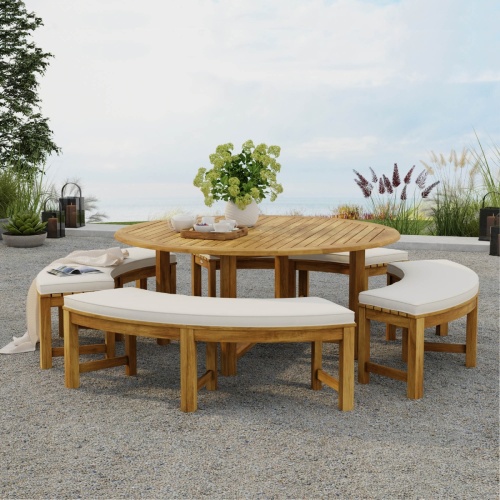 70090 Buckingham Picnic Dining Set showing Buckingham Round Table and 4 Backless Curved Benches with optional seat cushions on patio with water views and trees in background