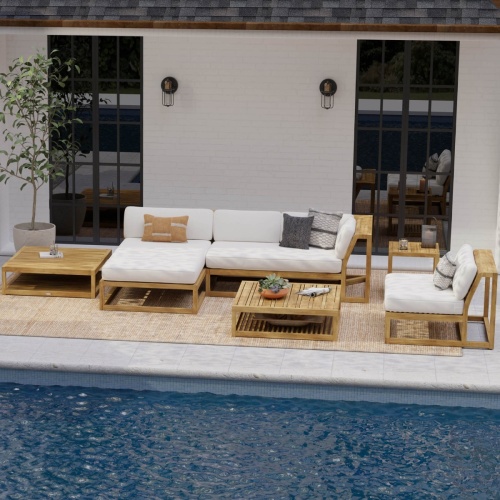 70231 Maya Deep Seating 6 piece teak Lounge Set with cushions with 2 potted succulents on 2 side tables and a coffee table with a black bowl of green apples on terrace with plants and ocean and blue skies in background
