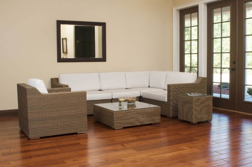 70242 malaga seven piece woven wicker set inside location on wood floors front view wall mirror  bowl mixed nuts floating candle magazines on glass top tables windows of outside patio