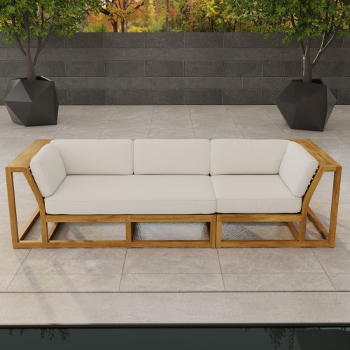 70277 Maya Deep Seating Sofa of Maya Right Side Sofa Sectional and Corner Sectional in front view on patio facing a pool with fence and trees in background