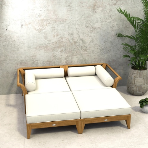70284  Aman Dais 4 pc Day Bed in angled side view on outdoor patio next to a wall and potted plant with ocean and blue sky background