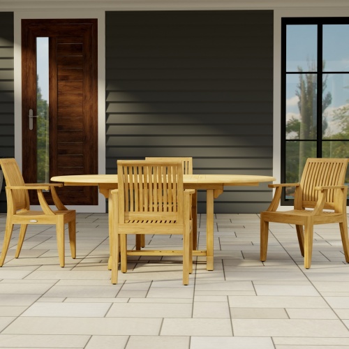 70305 Martinique 5 piece Dining Set of Martinique Oval Dining Table and 4 Laguna Dining Chairs in angled end view on stone patio with a house and pillar in the background