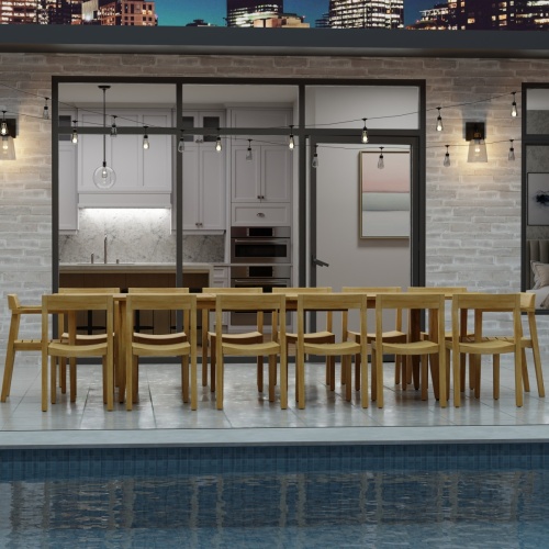 70353 Laguna 15 pc Teak Dining Set on tiled patio in angled side view and hanging patio lights and glass door and privacy fence in background
