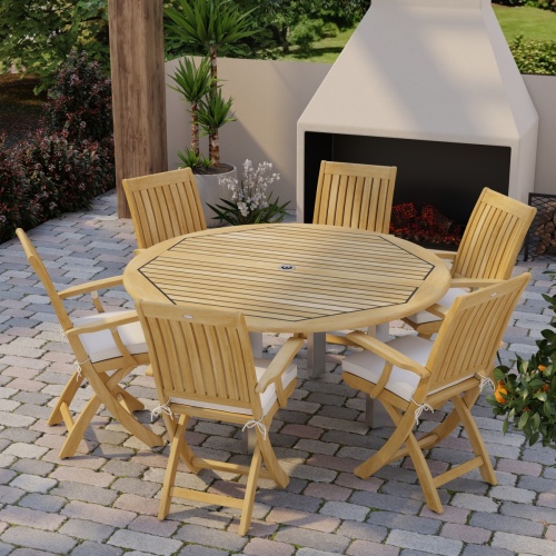 70357 Vogue Barbuda 7 pc Dining Set angled aerial top view on brick paver patio in front of an outdoor fireplace and landscape plants in background