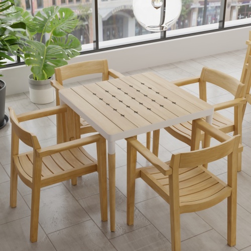 70388 Bloom Horizon 5 pc Dining Set showing Bloom Teak & Powder Coated Aluminum Square Table and 4 Horizon Armchairs angled aerial view with plant and windows in background