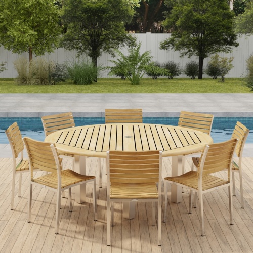 70444 Vogue Teak Dining Set for 8 with optional umbrella side angled view on outdoor deck  next to a pool with fence and plants and trees in background 
