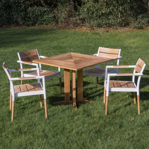 70452 Bloom Pyramid Bistro Dining Set of 4 Bloom teak and powder coated aluminum dining chairs and Pyramid 36 inch square teak dining table on grass with trees in background