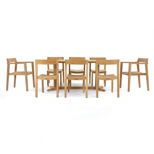 70462 Pyramid Horizon 9 pc Teak Dining Set  in angled side view on patio next to pool with landscape plants and privacy wall in background