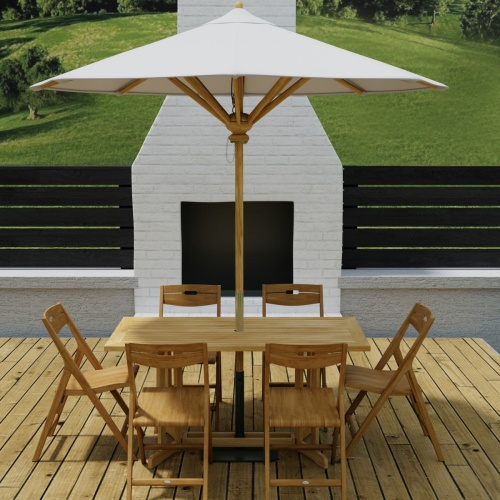 70472 Surf Nevis Teak 7 pc Dining Set of Nevis Dining Table and 6 Surf Folding Chairs in angled end view on wood deck with fireplace and fence with trees and hillside in background