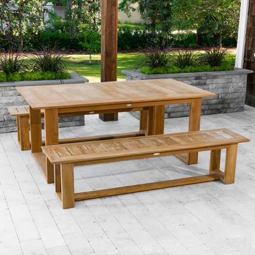 70497 Horizon teak Picnic Dining Set on concrete terrace under wood pergola with windows and lush vegetation in background