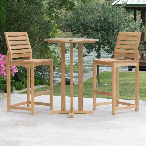 70499 Somerset 3 piece Bistro Bar Set on concrete patio with trees and lake in background and pool to right