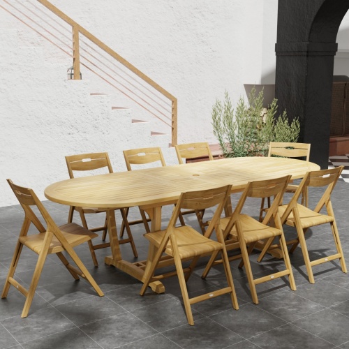 70516 Montserrat Surf 9 pc Dining Set in angled end view on stone patio with potted plant and stairs to house in background