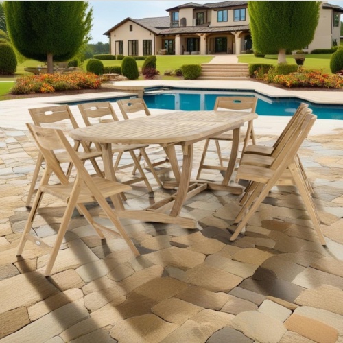 70537 Montserrat Surf 9 pc Dining Set of Monserrat Oval Dining Table and 8 Surf Folding Chairs angled end view on pavers with pool and landscaping plants and house in background