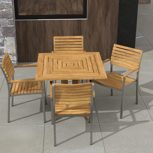 70575 Vogue Pyramid 5pc Dining Set of Pyramid 36 inch Square Dining Table and 4 Vogue Teak and Stainless Steel Stacking Arm Chair on patio with a picture and window in background