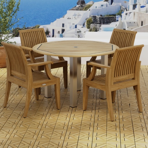 70620 Vogue Laguna Dining Set of Vogue Stainless Steel and Teak 4 ft Round Table and 4 Laguna Teak Dining Chairs on Teak Parquet terrace with potted plant and ocean in background