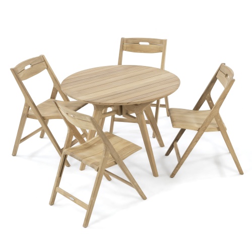70811 Surf Yacht teak round 42 inch Folding 5 piece Dining Set on terrace showing with 2 potted plants and book on table next to potted tree with mountain background