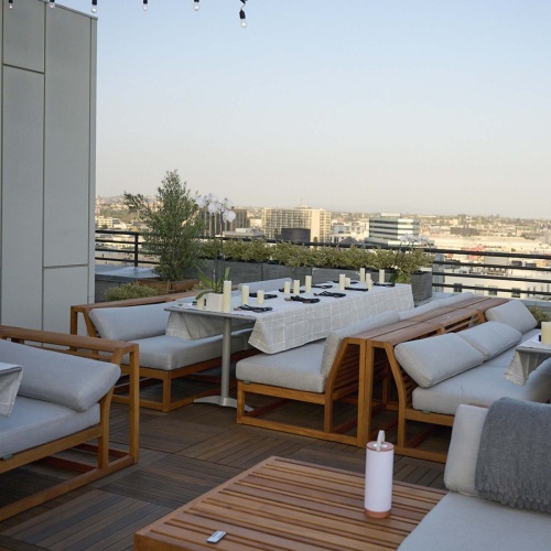 70882 Maya Laguna booth dining set on rooftop patio with city view and sky in background