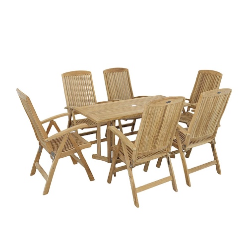 70903 Nevis Barbuda 7 piece Recliner Dining Set of 6 Barbuda dining chairs and Nevis teak rectangular table angled view on patio with landscaping trees and privacy fence in the background  