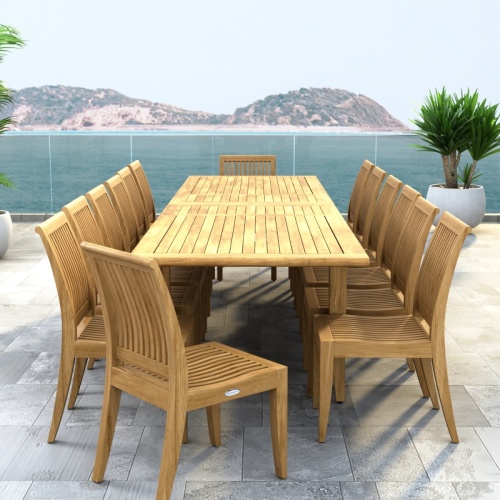 70917 Laguna 15 pc Teak Dining Set with optional umbrella in angled end view on tiled patio with palm tree and ocean in background