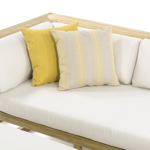 71005ccpg citrus glow throw pillow two tone with one side solid yellow and other geometric design set on sectional sofa on white background