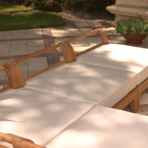 image of 72380MTO Aman Dais End Seat Cushion in canvas color on concrete patio with shrubs in background