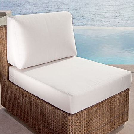 73103MTO Malaga Slipper Chair Cushion on Malaga slipper chair on concrete deck in front of pool with ocean and blue sky in background