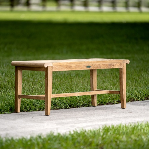 13915 Laguna 4 foot long teak Backless Bench with three folded towels back brush plant on top two hanging towels toiletries on niche in large walk in shower with white tile