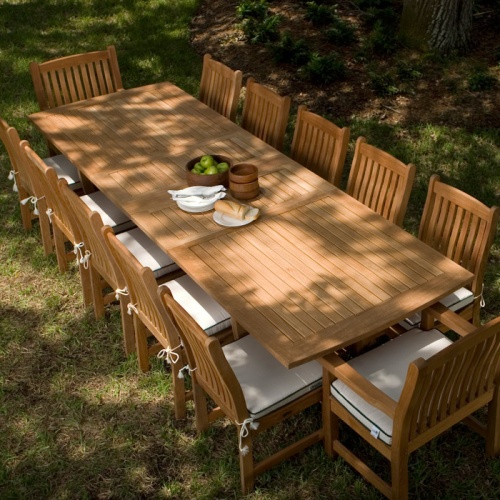 70017 Grand Veranda 13 piece Teak Dining Set with optional seat cushions overhead view on grass field
