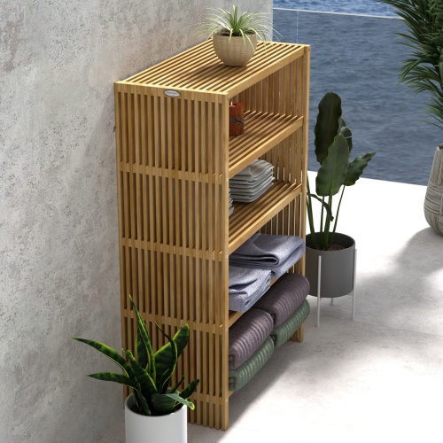 18221 Teak 48 inch Storage Shelf in angled aerial view between 2 potted plants against a wall with a potted plant on top of shelf and folded towels on the 3 lower shelves with ocean in back