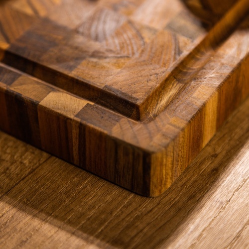 19123 Butcher Block 17 inch x 11 inch Rectangle Charcuterie Cutting Board angled view of corner on a table top