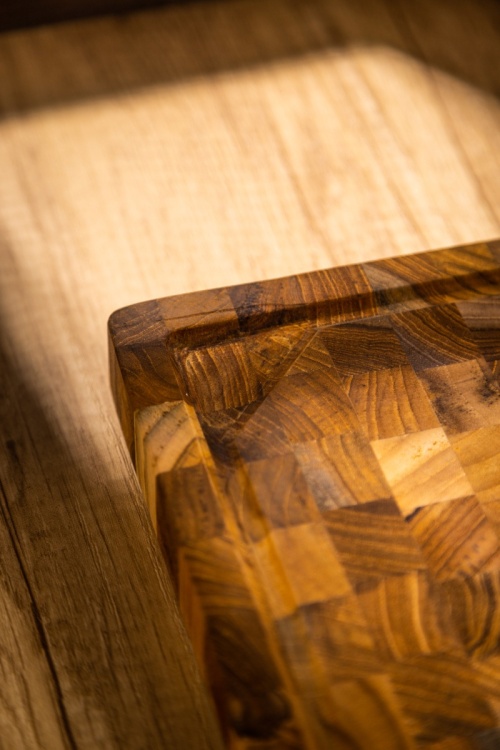 19124 Butcher Block 20 inch Rectangle Charcuterie Cutting Board showing closeup corner view on a counter top