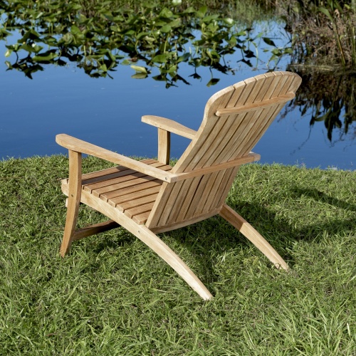 70000 Adirondack Chair in front angled view on green grass with vegetation and lake background
