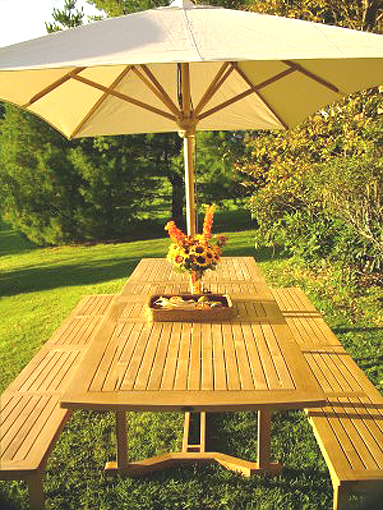 70065 Grand Veranda teak Picnic Bench Set with optional open market umbrella and flowers in vase woven basket on grass lawn landscape plants and tree in background