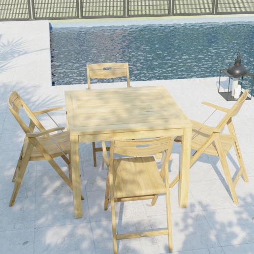 70147 Surf teak 36 inch square 5 pc Dining Set of 4 teak folding Dining Chairs and a teak 36 inch square dining table in angled aerial view on stone patio with windows in background