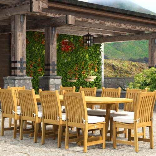 70166 Montserrat Veranda 11pc Dining Set with optional cushions on patio in angled end view with pergola with hanging plants and vines and landscape plants and hillside in background