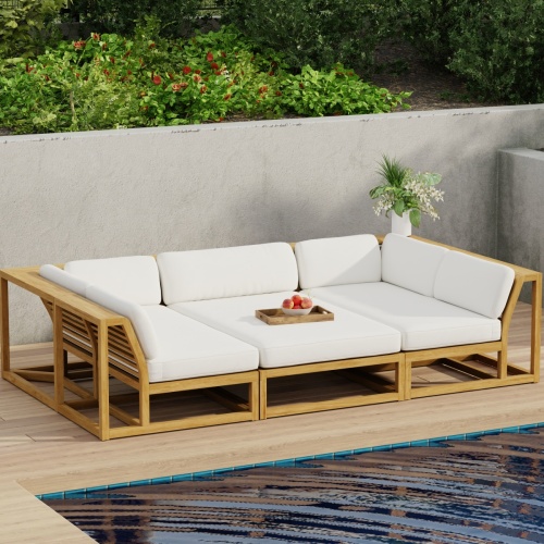 70274 Maya 3pc Daybed on patio in aerial front view with tray of fruit on middle daybed section facing a pool next to a potted plant with privacy wall with shrubs and trees in background