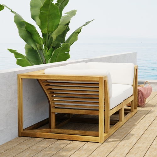 70275  Maya Love Seat of 2 Maya Corner Sectionals in angled front view on wood deck with a plant and ocean and blue sky in the background