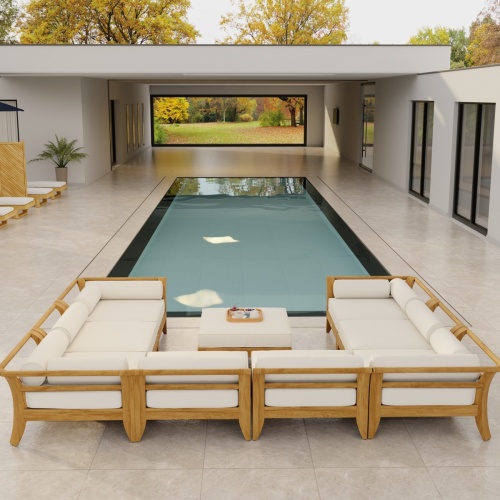70282 Aman Dais 9 pc teak Daybed Sectional Set with bolsters and cushions angled aerial view on tiled patio with glass door and privacy wall and trees in background 