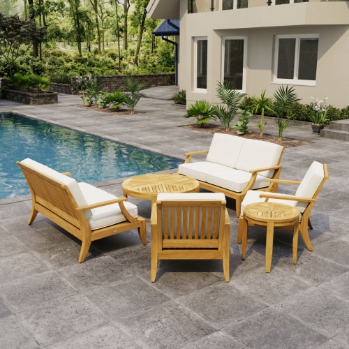 70347 Laguna 6 pc Sofa Set on paver patio facing a pool pavilion with landscaping plants and woods and trail in background
