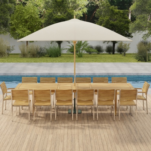 70352 Laguna Vogue 15 piece teak Dining Set of 14 dining armchair and rectangular 11 foot extendable dining table with optional umbrella in side angled view on pavers with pool in background
